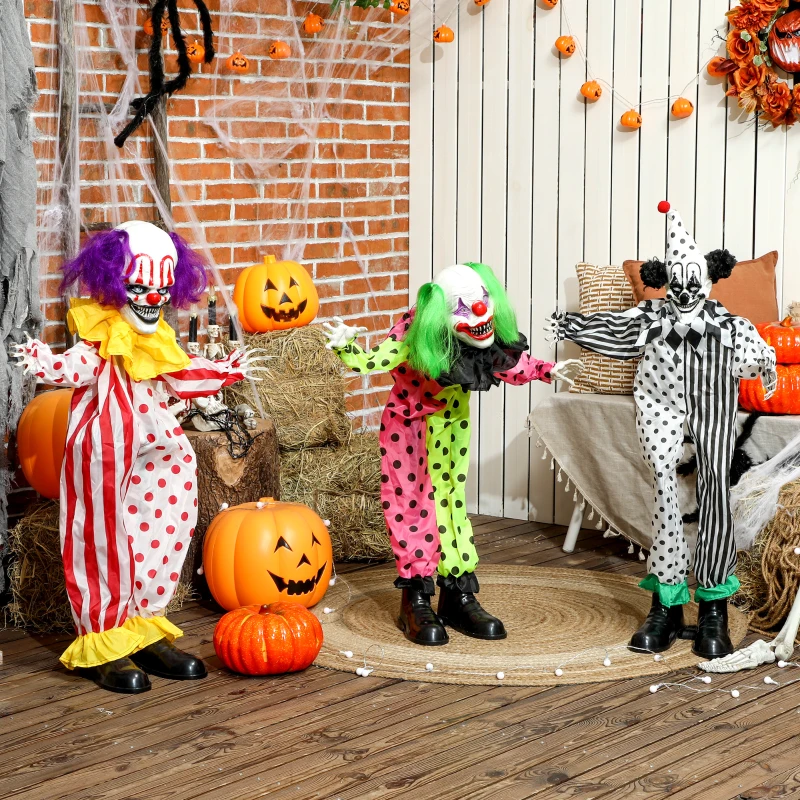 Three creepy clowns in colorful costumes with pumpkins, hay bales, and cobwebs for Halloween outdoor décor.