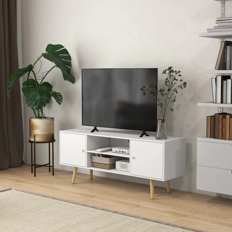 Modern living room with white TV stand, flat screen, and plant.