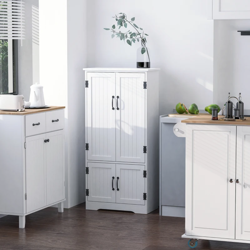 White compact pantry cabinet with double doors placed in a bright kitchen corner.