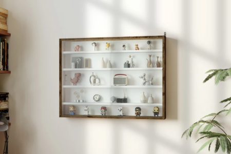 Wall-mounted glass display cabinet with collectibles inside.