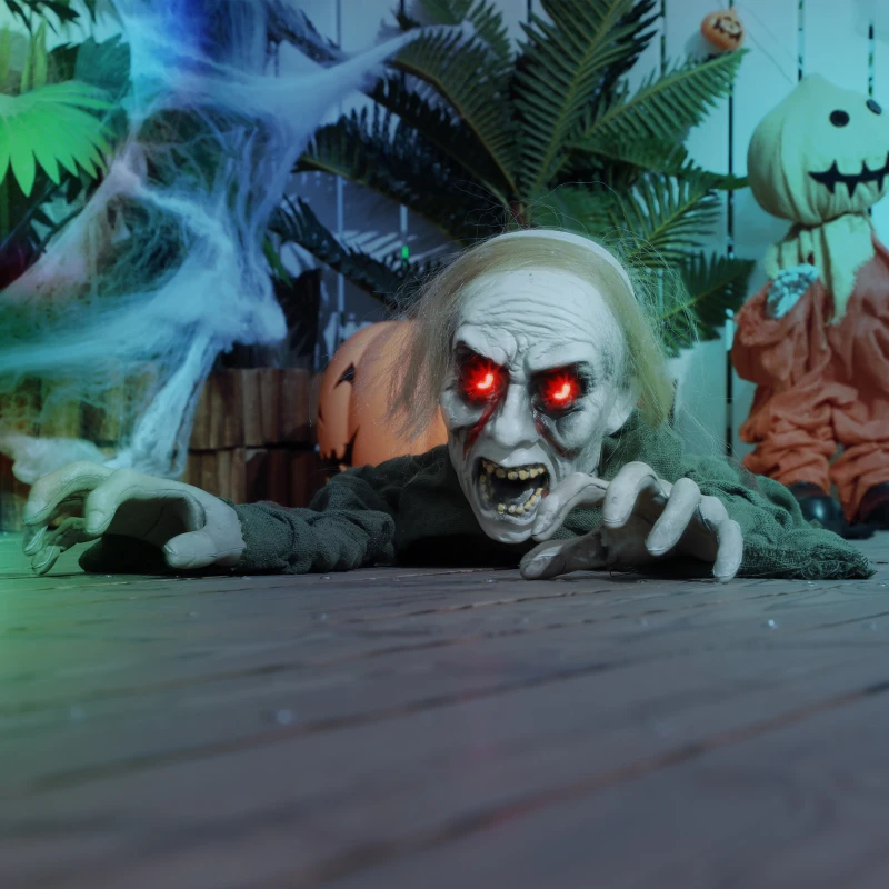 Crawling zombie with glowing red eyes on wooden floor Halloween setup.