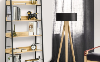 Oak-finish bookshelf with metal frame styled in living room.