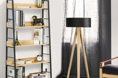 Oak-finish bookshelf with metal frame styled in living room.