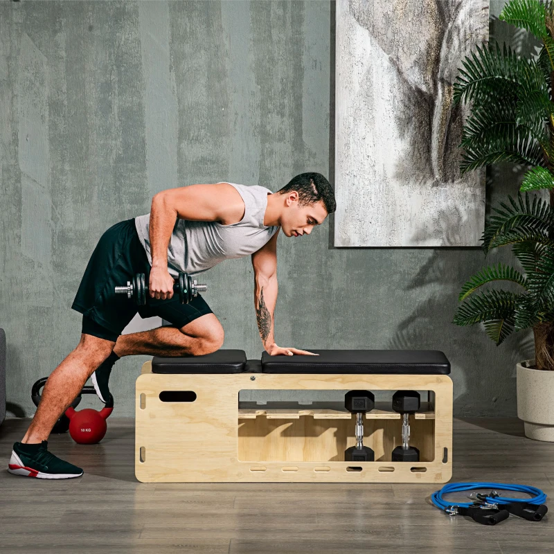 Man training on wooden workout bench with dumbbell storage