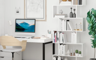 White S-shaped wooden bookcase styled with books and modern décor.