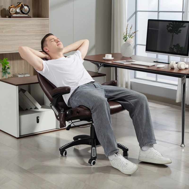 Man relaxing on black reclining massage chair with extended leg rest