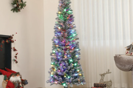 Slim pre-lit Christmas tree with colorful lights and wrapped gifts underneath.