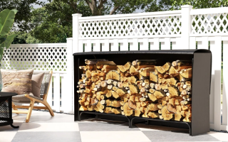 Outdoor patio firewood rack loaded with logs under black weatherproof cover
