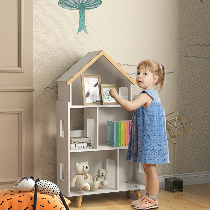 Lifestyle image of a child using the assembled Qaba 3-tier toy organizer filled with books, toys, and decorations.