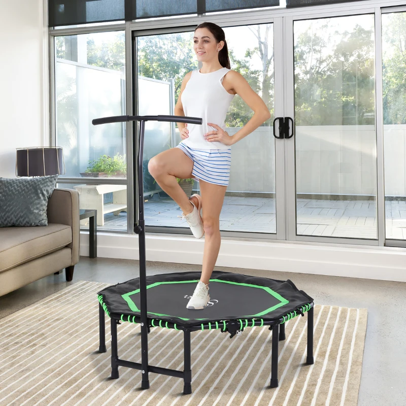 Woman exercising indoors on a small foldable trampoline with handle bar