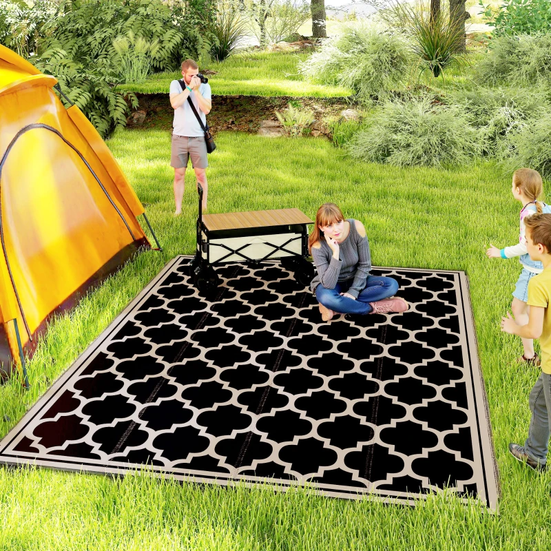 Large reversible outdoor RV rug with family enjoying patio seating