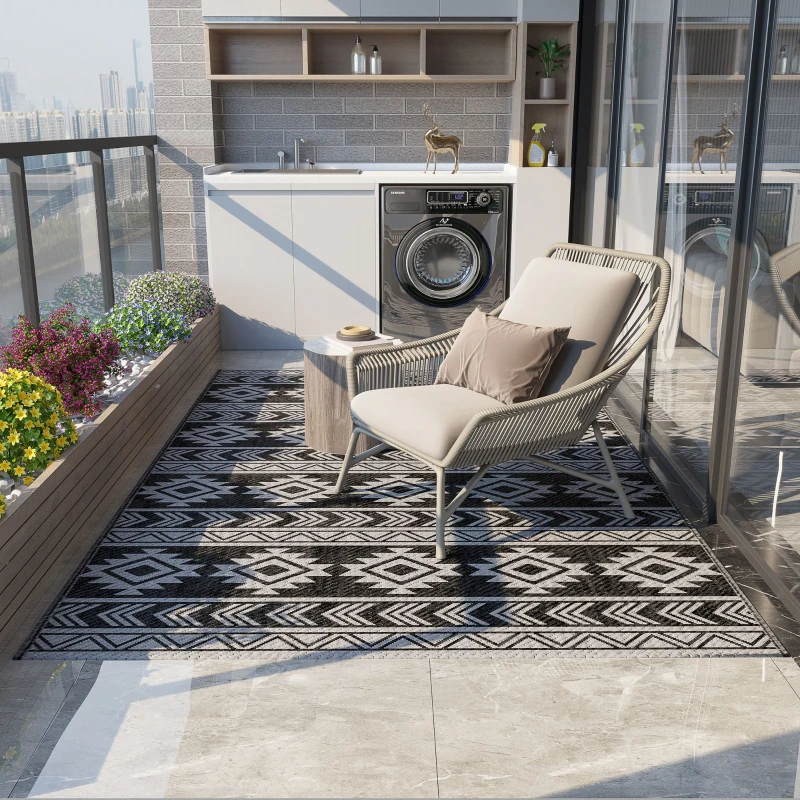 Black and grey reversible rug on balcony patio with chair