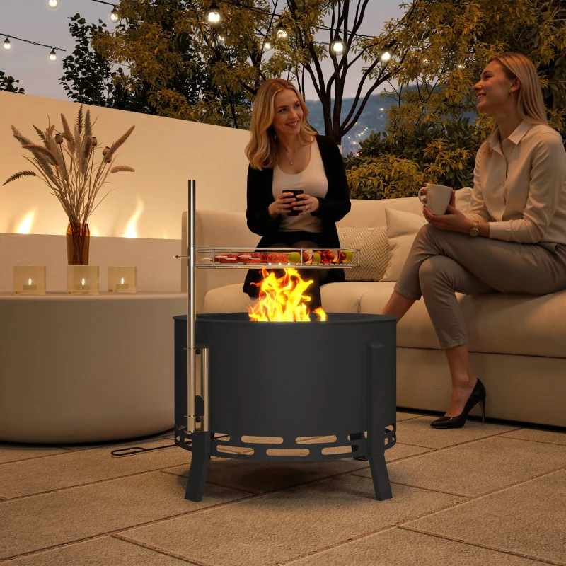 Round metal fire pit with cooking grate on patio
