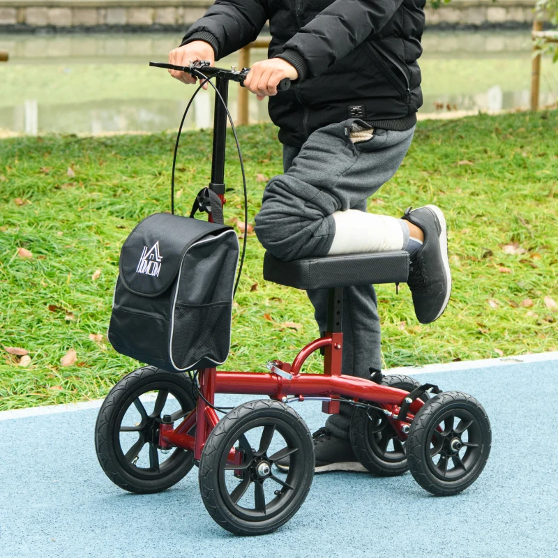 Person with leg injury using red knee scooter outdoors on pathway.