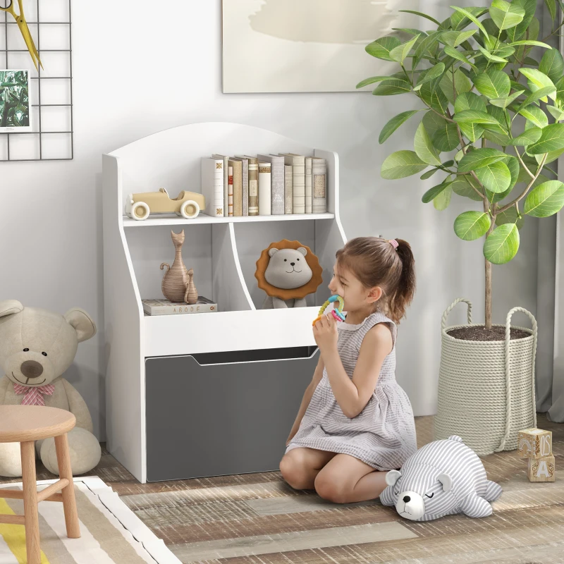 Little girl sitting near white and gray kids bookcase with books, toys, and decor in a cozy playroom setting.