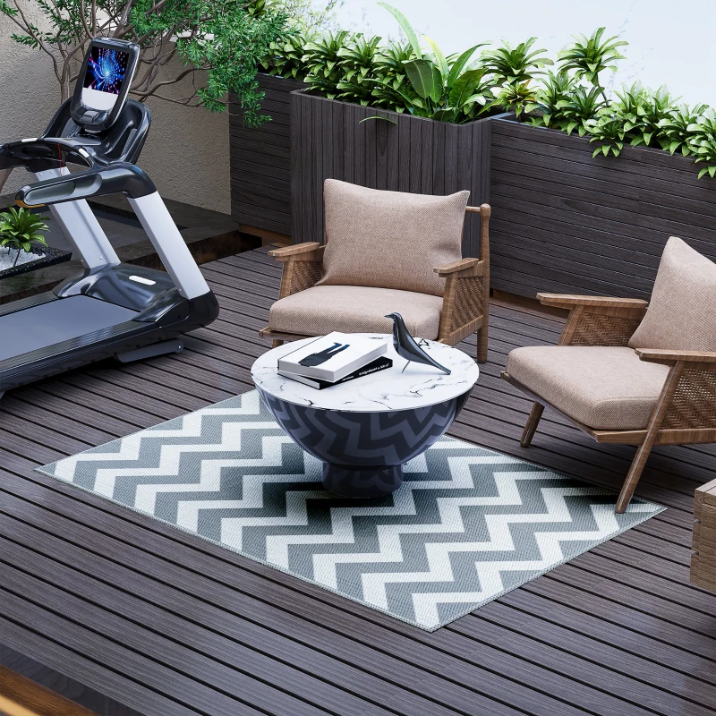 Black and white toothed rhombus reversible outdoor rug on patio with sofa set