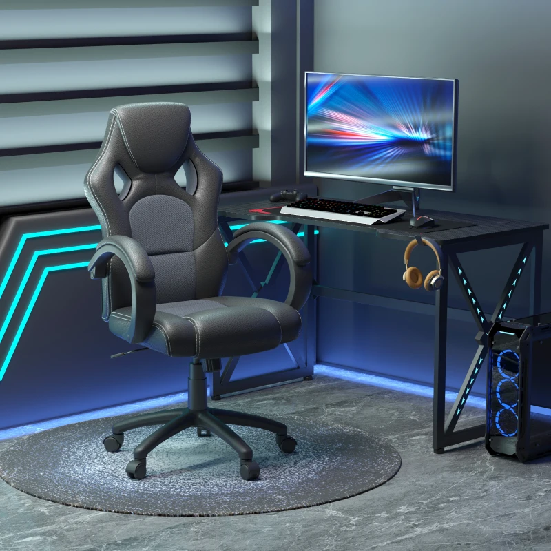 Black and Grey racing gaming chair placed beside illuminated PC desk setup
