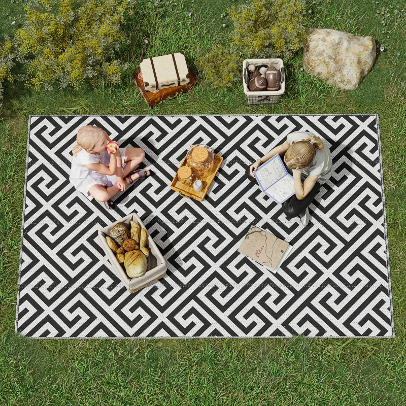 Grey and white rhombus reversible RV rug on patio with family