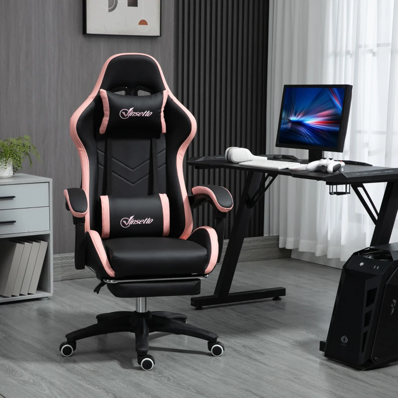 black and pink ergonomic gaming chair with footrest beside modern computer desk