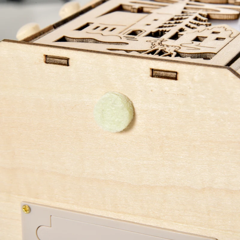 Close-up of wooden advent calendar base showing felt pad and carved design.