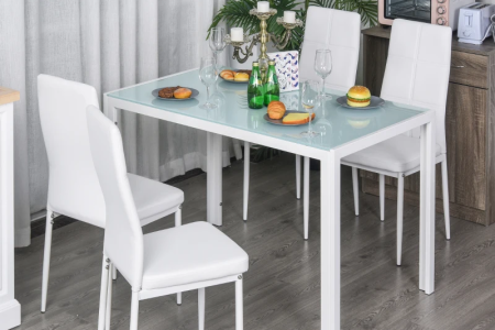 Modern white glass kitchen table and chairs set in dining room setup.