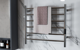 Modern bathroom featuring sleek chrome towel warmer on marble wall.