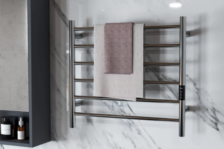 Modern bathroom featuring sleek chrome towel warmer on marble wall.