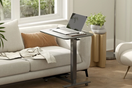 Finished adjustable standing desk with laptop setup in a modern living room.