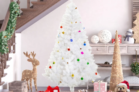 White Christmas tree decorated with blush ornaments and ribbon in cozy living room