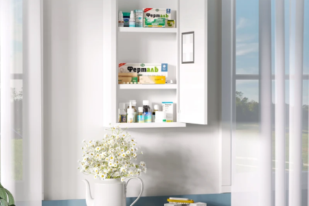 Completed wooden medicine cabinet organized with skincare and first-aid items.