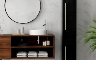 Minimal beige bathroom with towel rack, vanity, laundry basket, and bath mat.