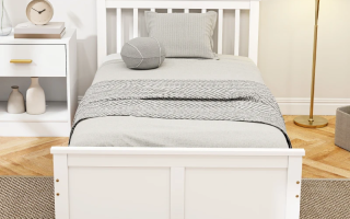 Modern twin bed with layered bedding, neutral tones, and cozy morning light.