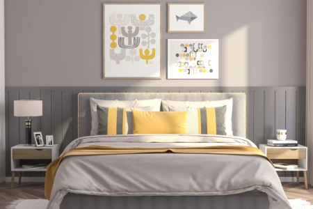Modern bedroom with grey and yellow bedding, wall art, and coordinated nightstands.