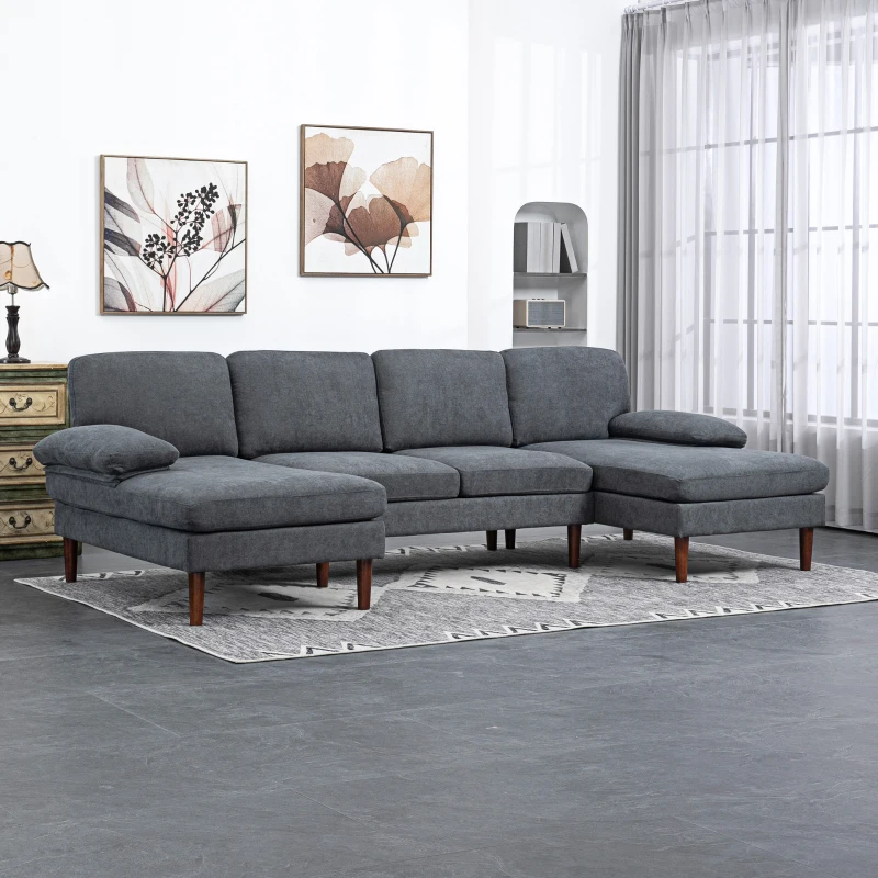Spacious living room featuring dark grey U-shaped sectional sofa with soft cushions and wall art.