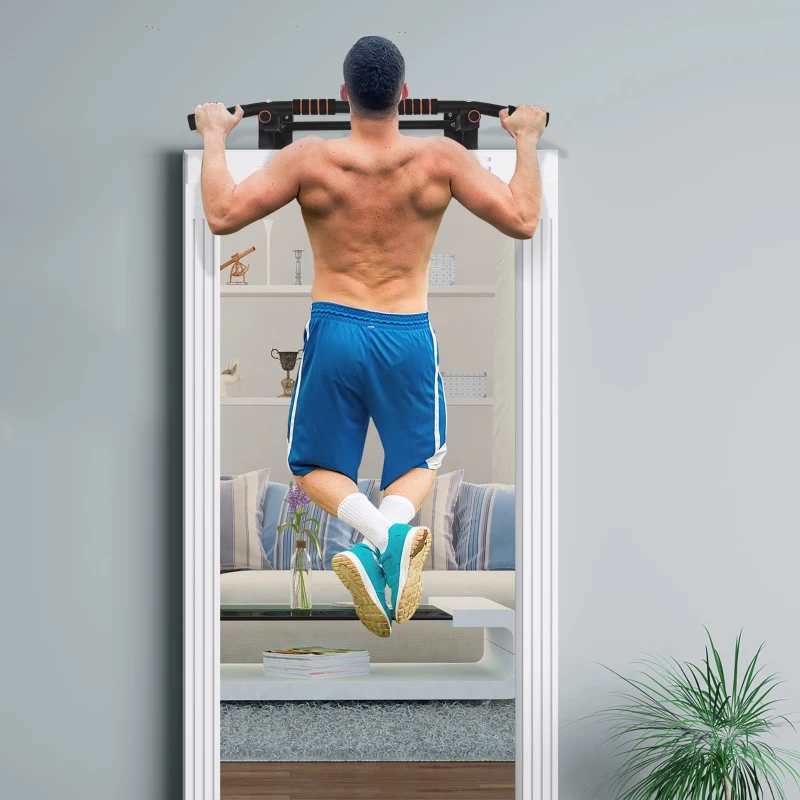 Man performing chin-ups on wall-mounted pull-up bar in living room.