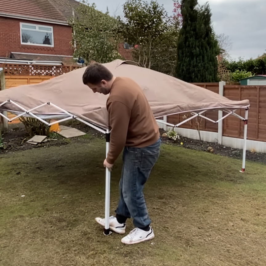Person raising telescoping legs to secure pop-up canopy.