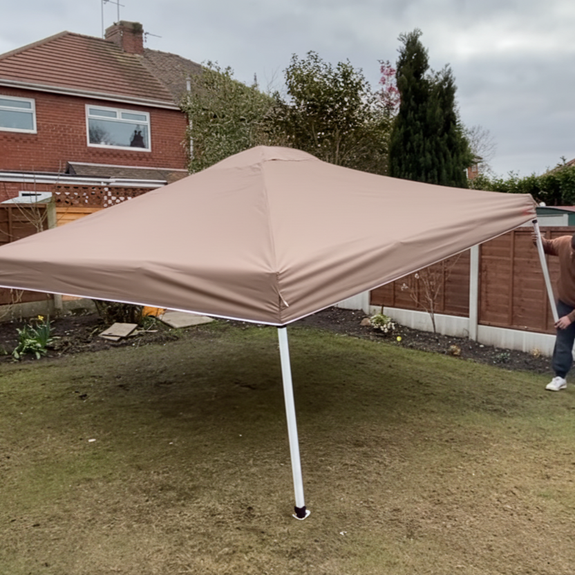 Man extending pop-up tent legs to full standing height.