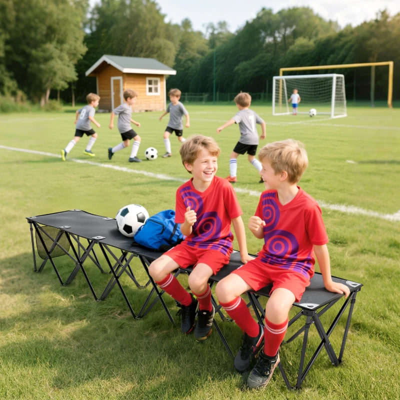 Kids sitting on folding sports bench watching soccer game on field.