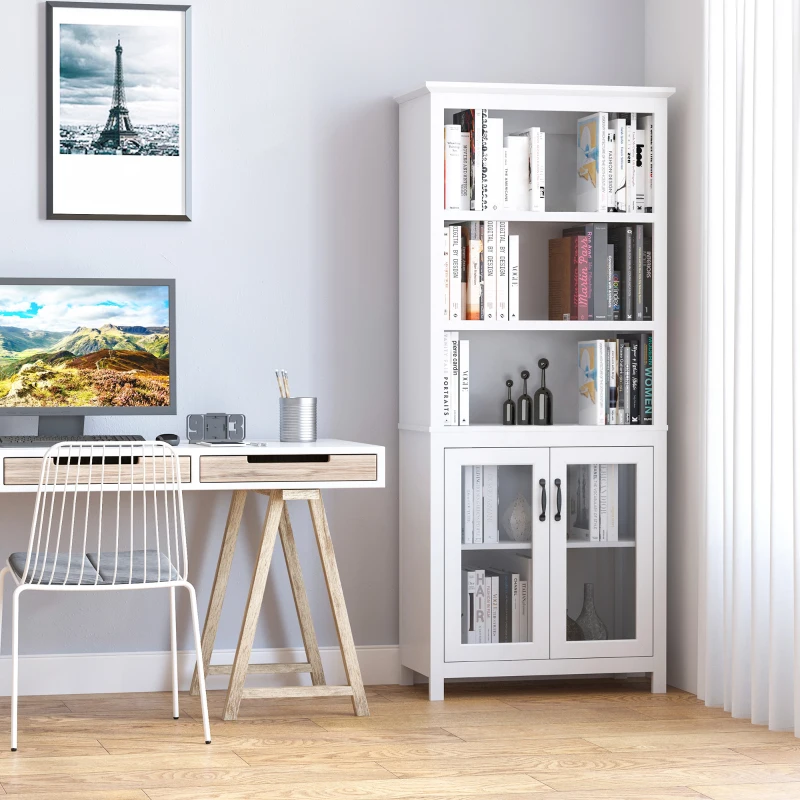 White glass-door bookshelf with books and décor beside study desk.