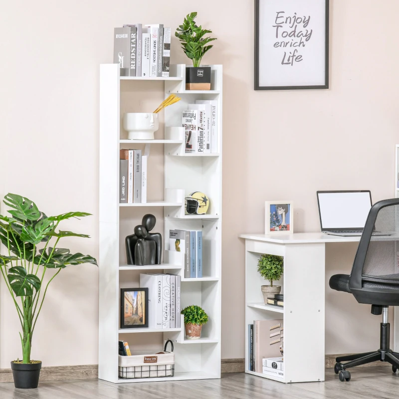 Tall white bookshelf filled with books, plants, and decorative pieces near desk.