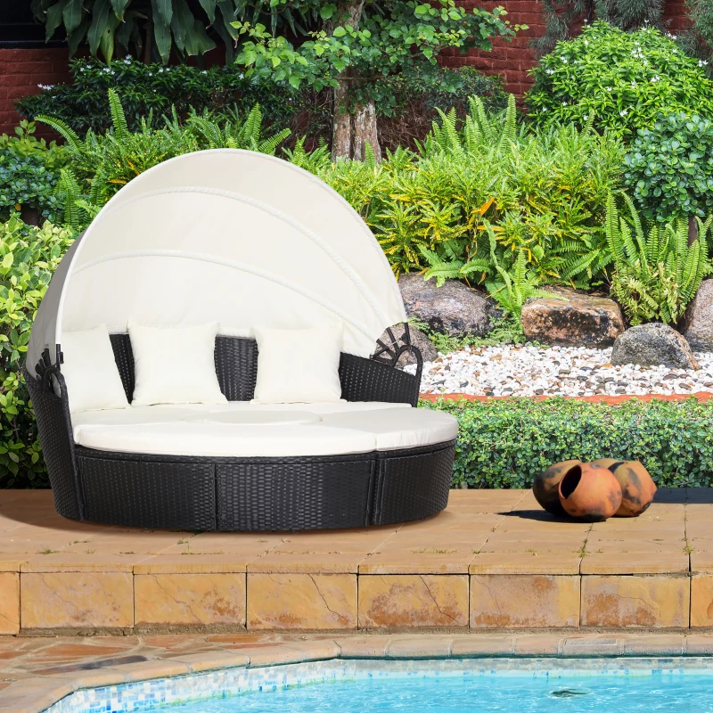 Round daybed under garden lights creating cozy evening outdoor atmosphere.