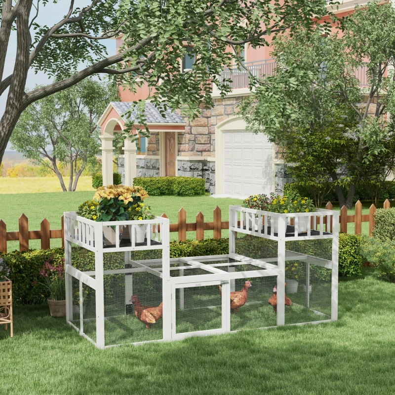 White wooden chicken coop with planter shelves and hens inside on a green lawn.