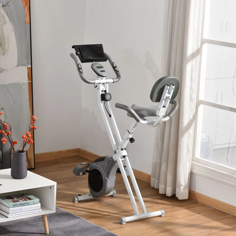 grey foldable upright bike near window in modern home.
