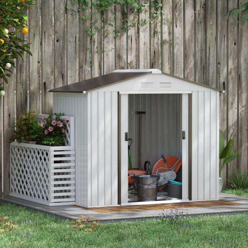 Silver outdoor storage shed beside wooden fence, filled with garden tools and equipment.