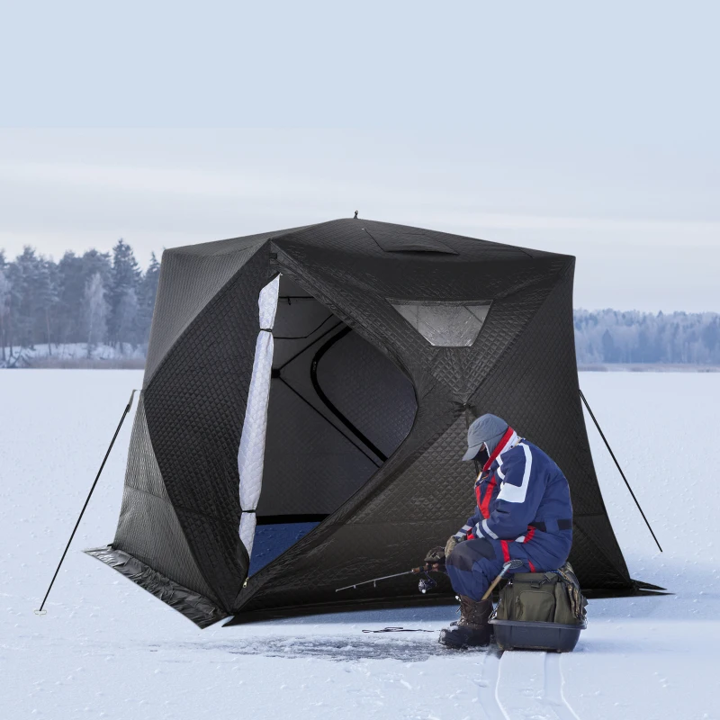 Black insulated tent set up on frozen lake with fisherman.