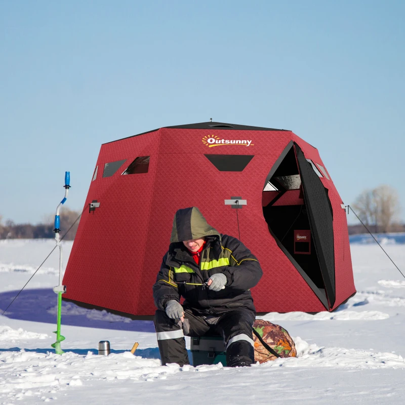 Red insulated ice fishing tent with man fishing in snow.