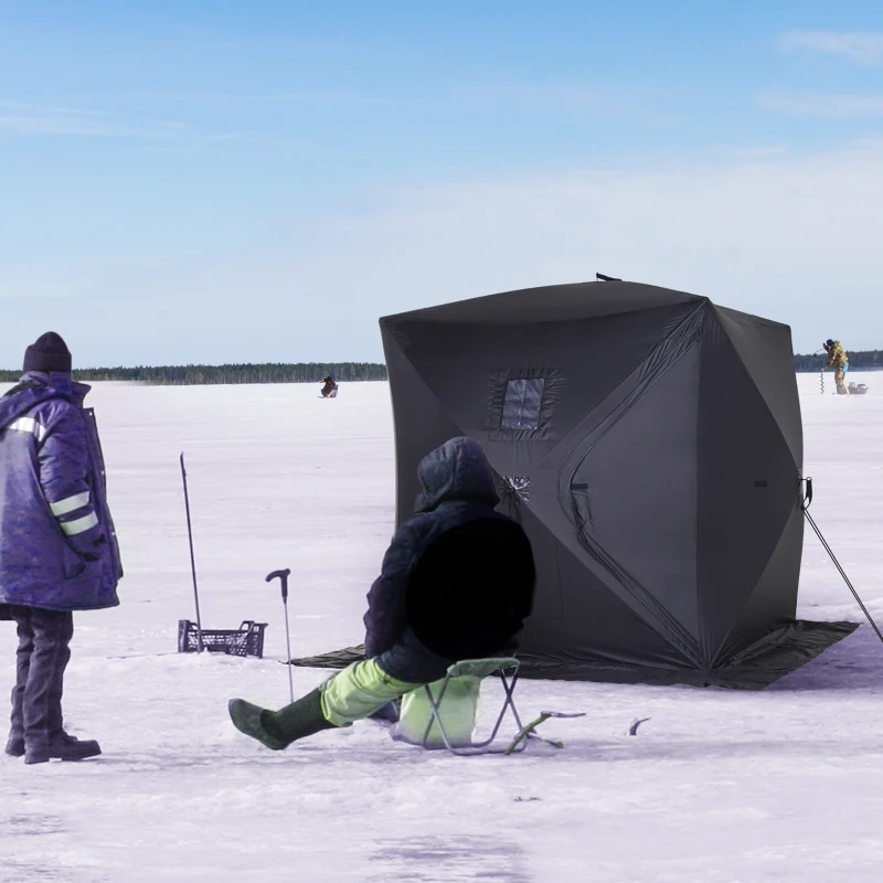 Black pop-up ice fishing tent with anglers on snowy lake.