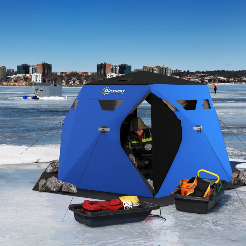 Black pop-up ice tent near city buildings and fishing gear.