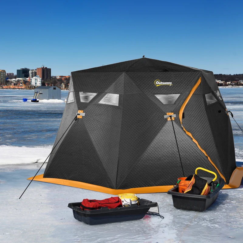 Black insulated tent on frozen lake beside fishing gear.