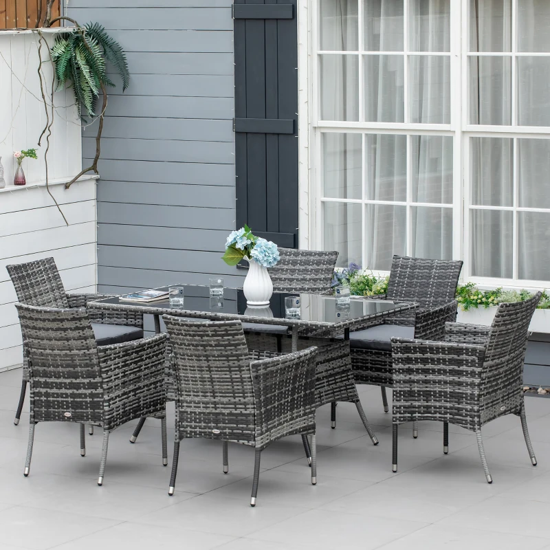 Swivel patio dining set with grey umbrella and mesh chairs on wooden deck.